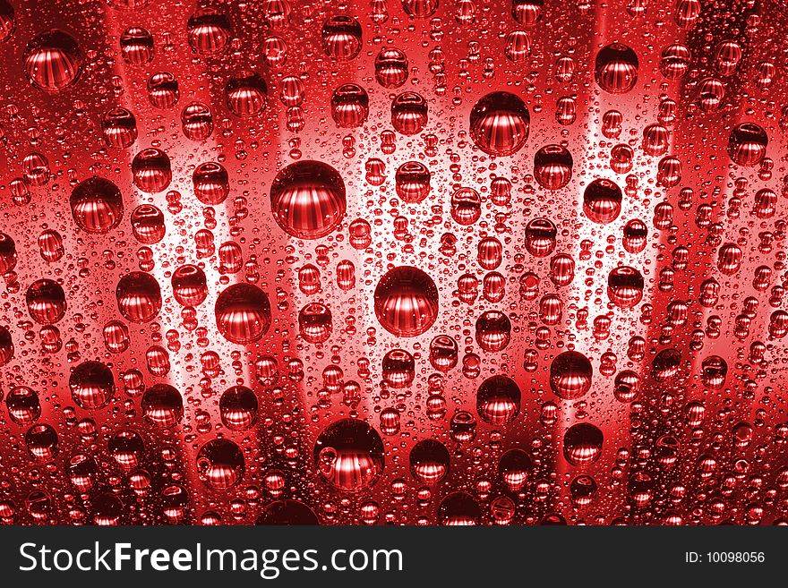 Red water drops against black background
