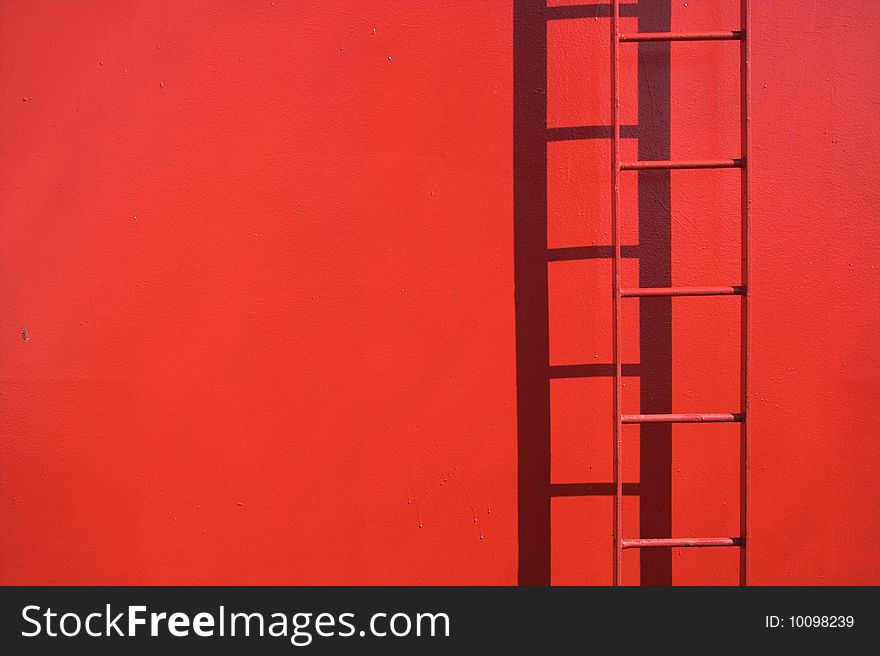 Fixed red ladder with copy space. Detail from a ship. Ladder in focus.