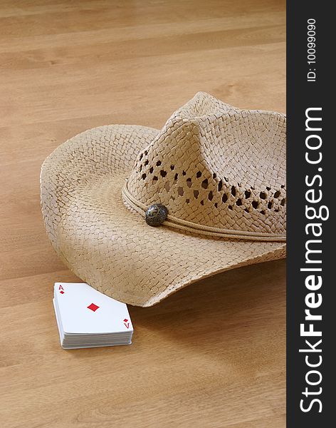 A deck of cards and a hat are holding the table for the comming players. A deck of cards and a hat are holding the table for the comming players.