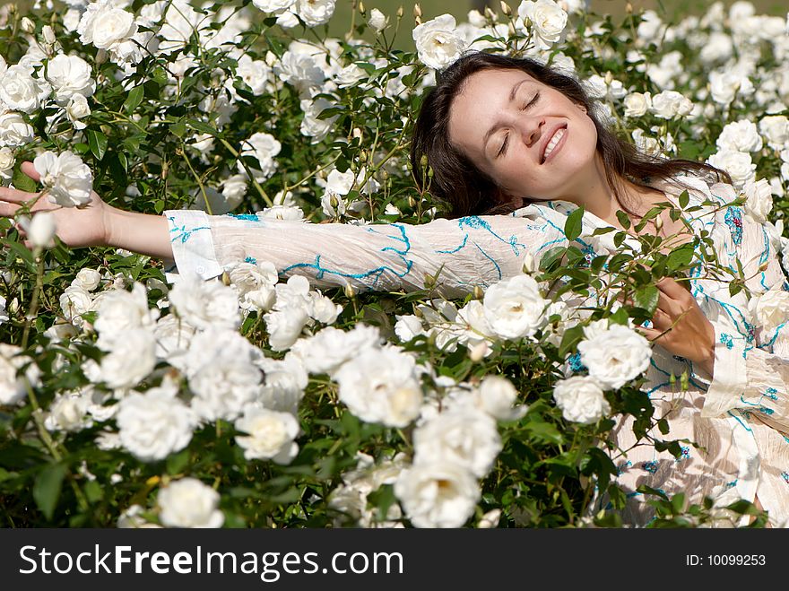 Fine young women in white roses. Fine young women in white roses