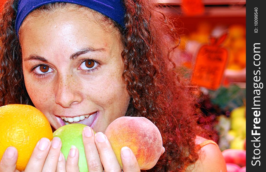 Close up of woman in a fruit market holding fruit in her hands. Close up of woman in a fruit market holding fruit in her hands