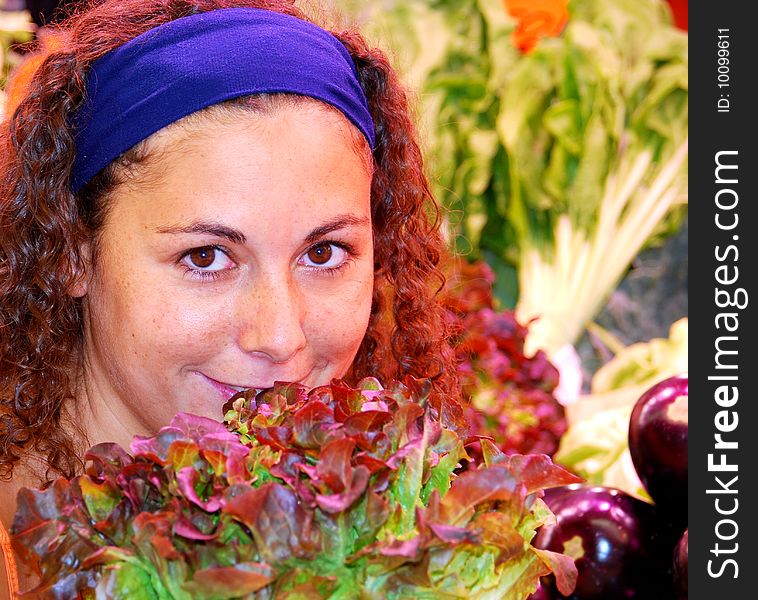 Close up of woman standing behind salad and eggplants. Close up of woman standing behind salad and eggplants