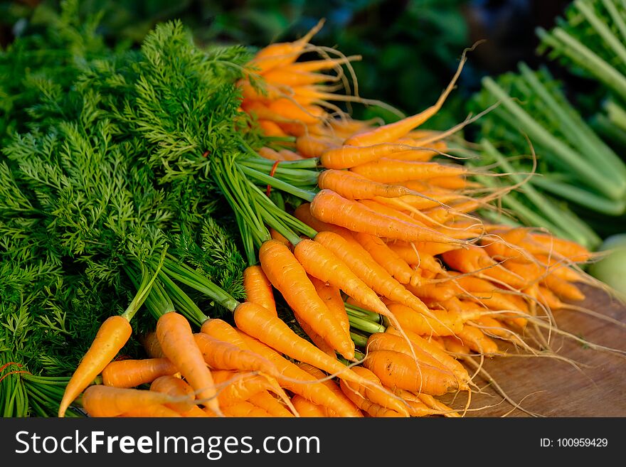 Fresh and sweet carrot on a grey wooden table. Fresh and sweet carrot on a grey wooden table