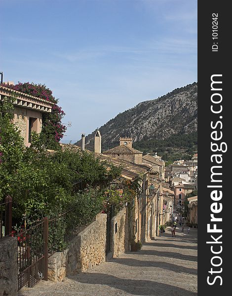 Spanish village on hillside with cobbled steps and people. Spanish village on hillside with cobbled steps and people