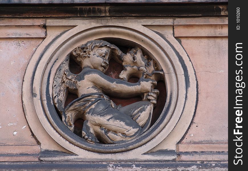 Sculptured motif of child holding branch