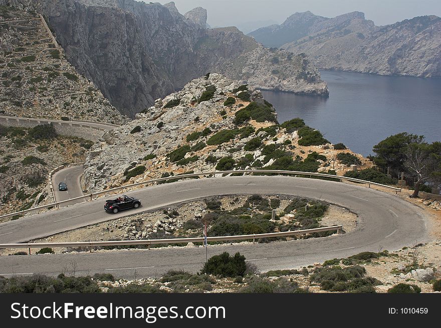 Winding road through mountains overlooking sea. Winding road through mountains overlooking sea