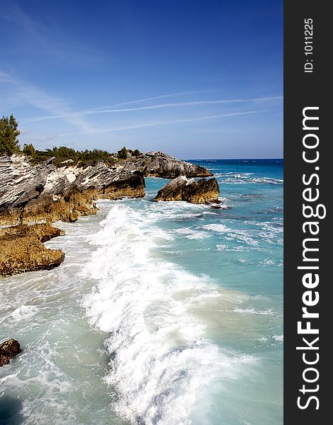 A tropical coast line with large crashing waves. A tropical coast line with large crashing waves