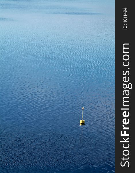 Yellow buoy, seamark for beaches, in the water. Yellow buoy, seamark for beaches, in the water