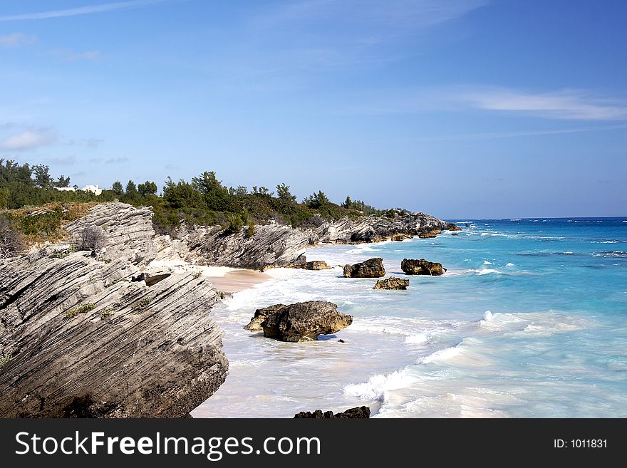 A tropical coast line with large crashing waves. A tropical coast line with large crashing waves