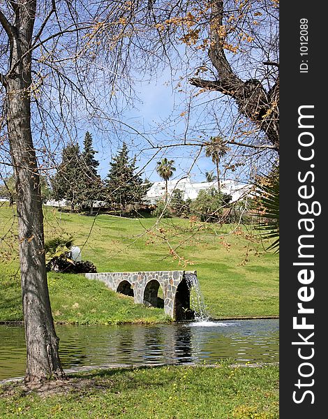 Waterfall from man made bridge pouring water into lake in Spain. Waterfall from man made bridge pouring water into lake in Spain