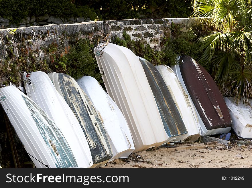 A bunch of small boats in the sand. A bunch of small boats in the sand