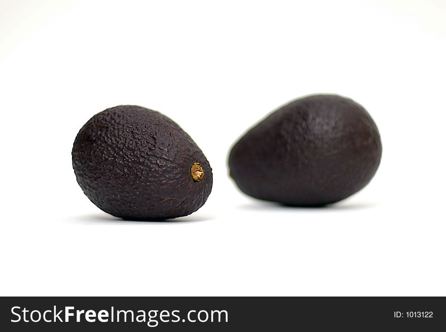 Two avocados against white
