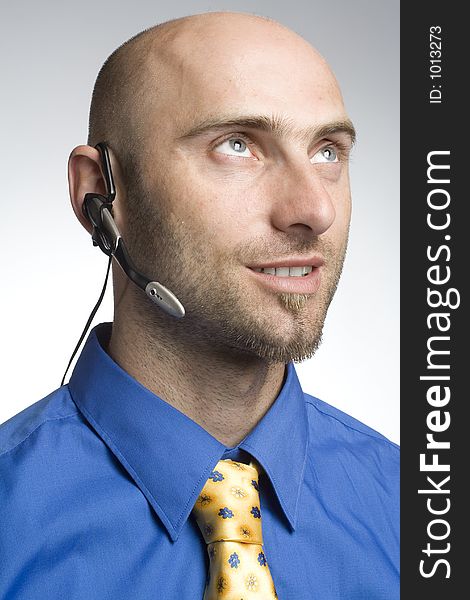 Handsome businessman with phoneheadset. Handsome businessman with phoneheadset