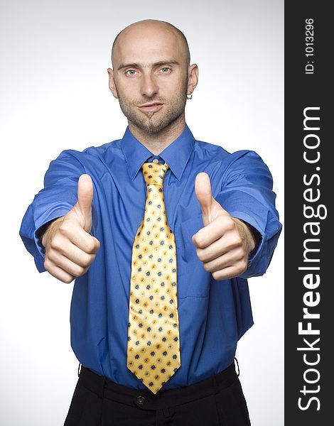 Young businessman with his thumbs up. Young businessman with his thumbs up