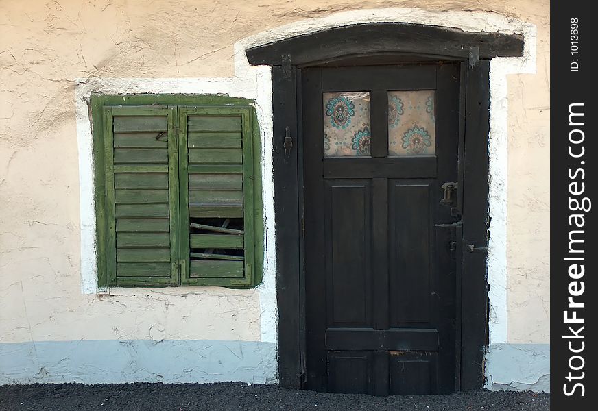 Tiny door and window with green shutters. Tiny door and window with green shutters