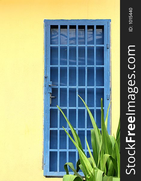 Yellow wall and blue door. Yellow wall and blue door