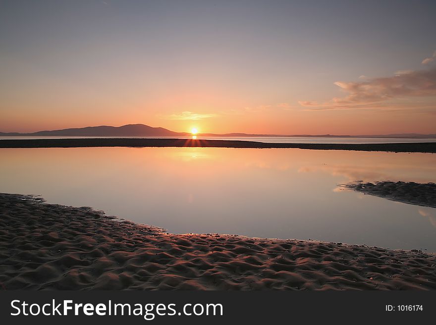 Sunset over mountain,reflection in tidal pool