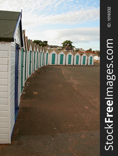 Line of beach huts at typical English seaside.