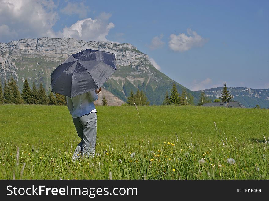 Woman with her umbrella in the countryside
