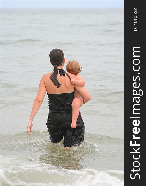 Mother and child take a dip in the Ocean. Mother and child take a dip in the Ocean