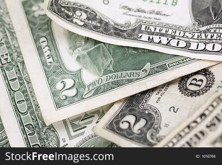 Pile of two dollar bills (and a one dollar bill) - horizontal format - narrow depth of field. Pile of two dollar bills (and a one dollar bill) - horizontal format - narrow depth of field