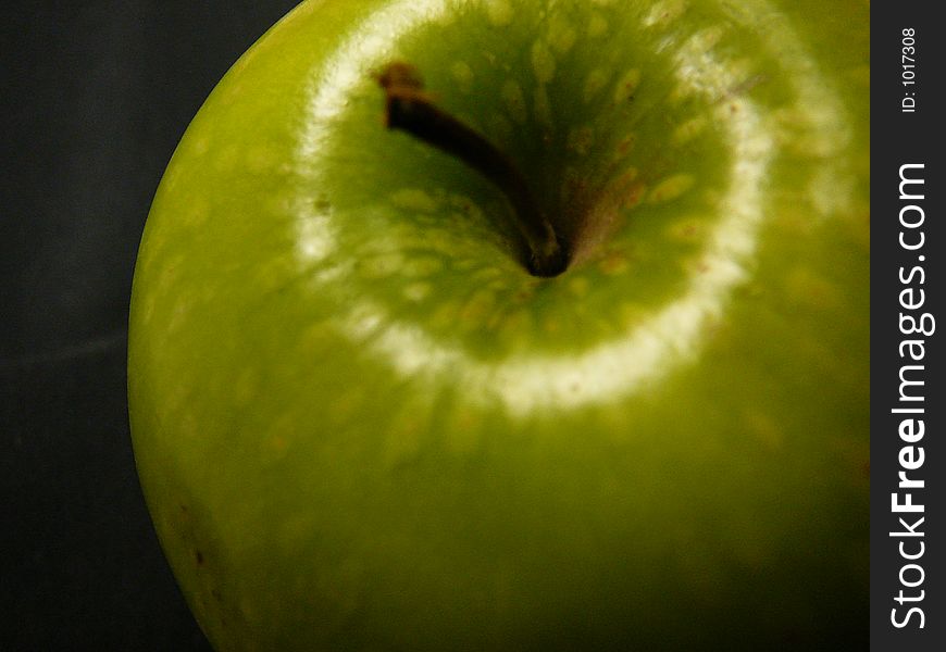 Big Granny Smith apple on a black background.