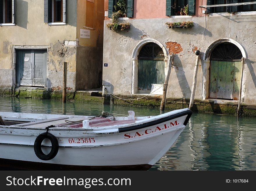 Boat in canal in Venice, Italy. Boat in canal in Venice, Italy.