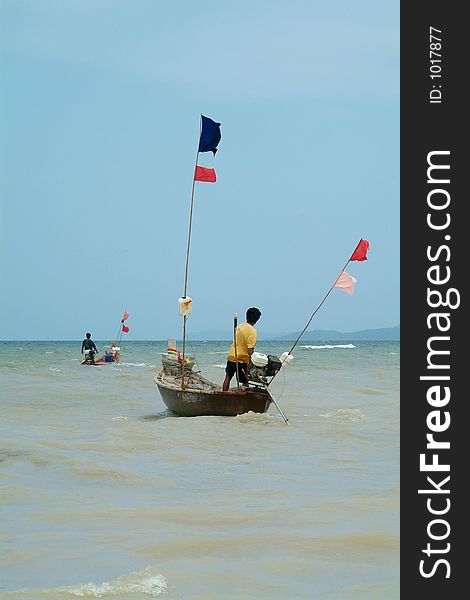 Two wooden, longtail fishing-boats leaving the coast of Na Jomtien, Chonburi province, Thailand. Two wooden, longtail fishing-boats leaving the coast of Na Jomtien, Chonburi province, Thailand