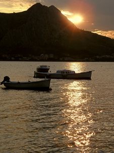 Reflexion Of Light In The Sunset With Boats Stock Image