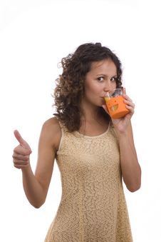 Woman Is Drinking Orange Juice And Showing OK. Royalty Free Stock Photography Woman Is Drinking Orange Juice And Showing OK. Royalty Free Stock Photography