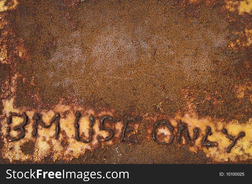 Welded lettering on a rusted steel plate. text reads BM use only