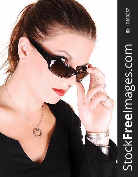 Elegant lady looking over her sunglasses and wearing a black dress
for white background in the studio. Elegant lady looking over her sunglasses and wearing a black dress
for white background in the studio.