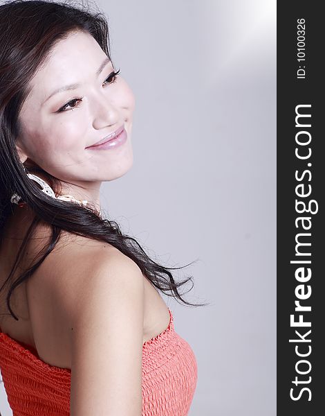 Asian young woman's portrait,isolated on grey background. Asian young woman's portrait,isolated on grey background.