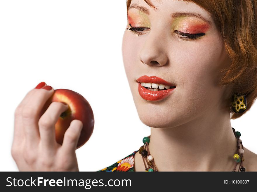 Portrait of young woman looking at apple. Portrait of young woman looking at apple