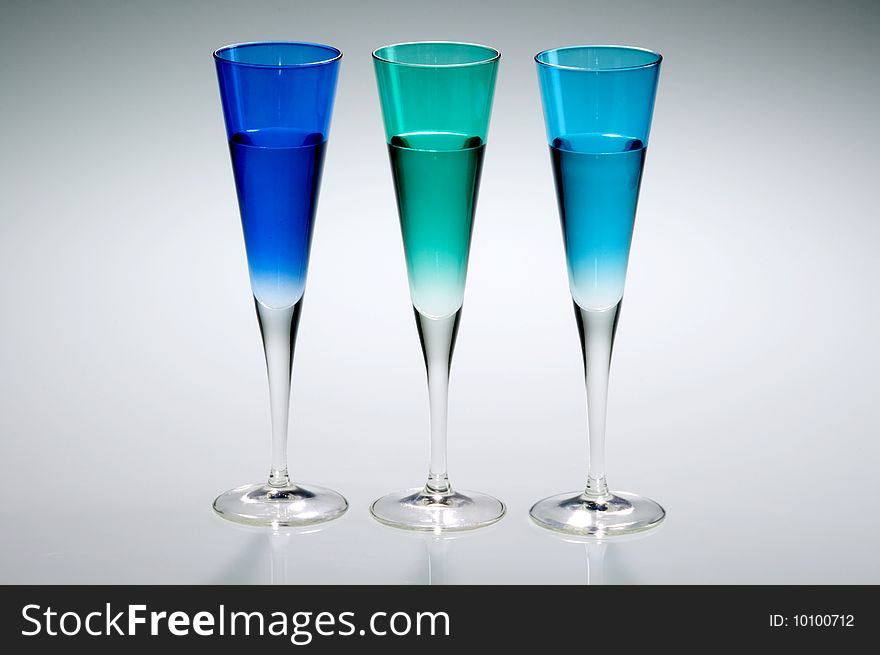 Three cocktail flutes, blue, green and turquoise. Three cocktail flutes, blue, green and turquoise.