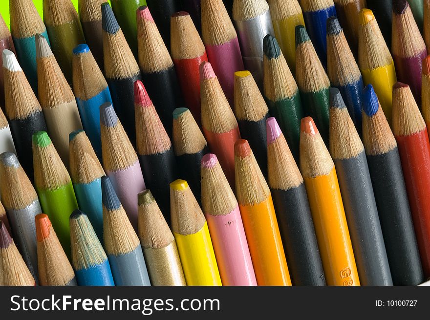 Colored pencil set used by an artist, points are not sharp, wide array of colors, angled view. Colored pencil set used by an artist, points are not sharp, wide array of colors, angled view.