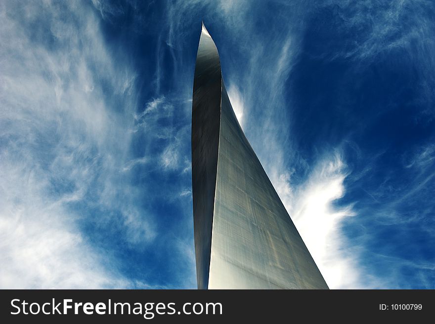 Twisted Metallic Pillar with clouds flaring across the sky