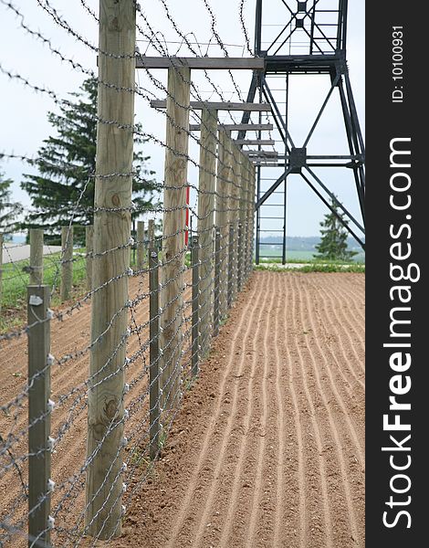 Barbed wire fence with clouds in background - frontier protection. Barbed wire fence with clouds in background - frontier protection