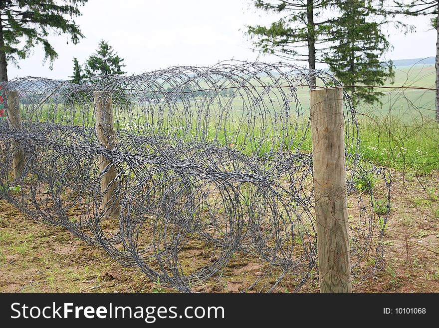 The spiral of barbed wire protects border between the states. The spiral of barbed wire protects border between the states