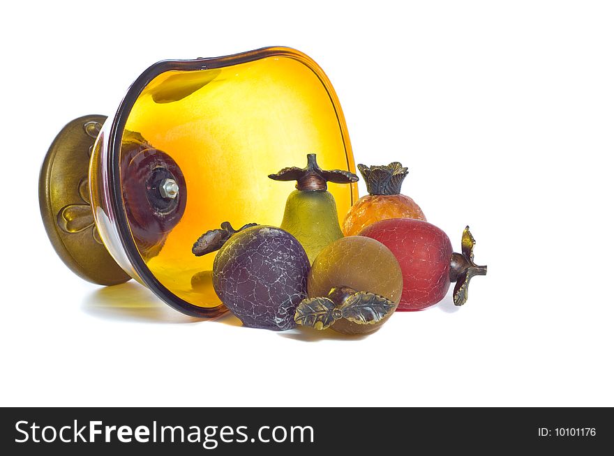 Glass bowl full of glass fruit spilling out of bowl. Glass bowl full of glass fruit spilling out of bowl