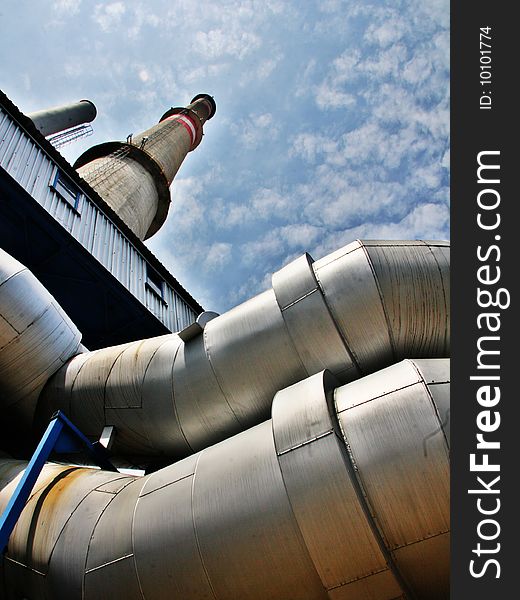 High chimney, pipes and blue sky