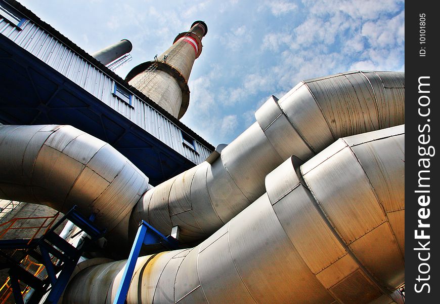 High chimney, pipes and blue sky