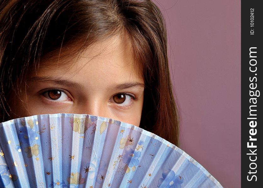 Portrait of young girl with fan.