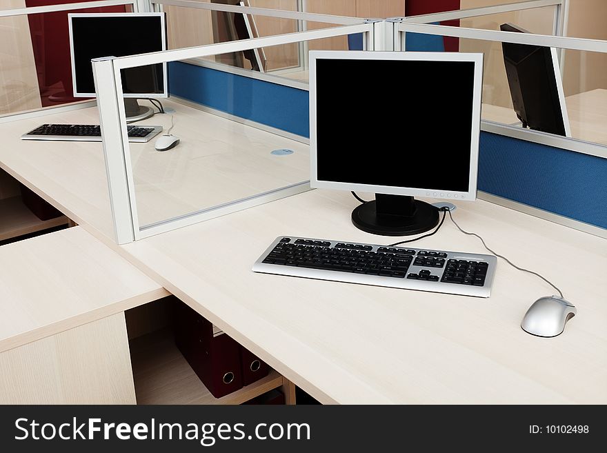 Computers behind the glass in a modern office