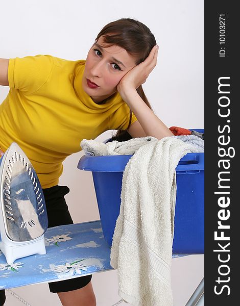 Woman with basket of clothing over white background. Woman with basket of clothing over white background