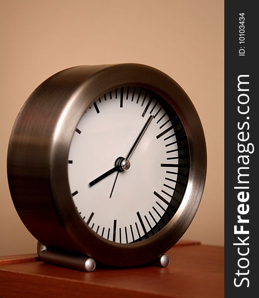 Simple clock on top of a bookcase