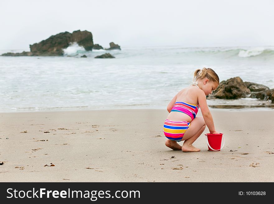 Girl Playing In The Sand