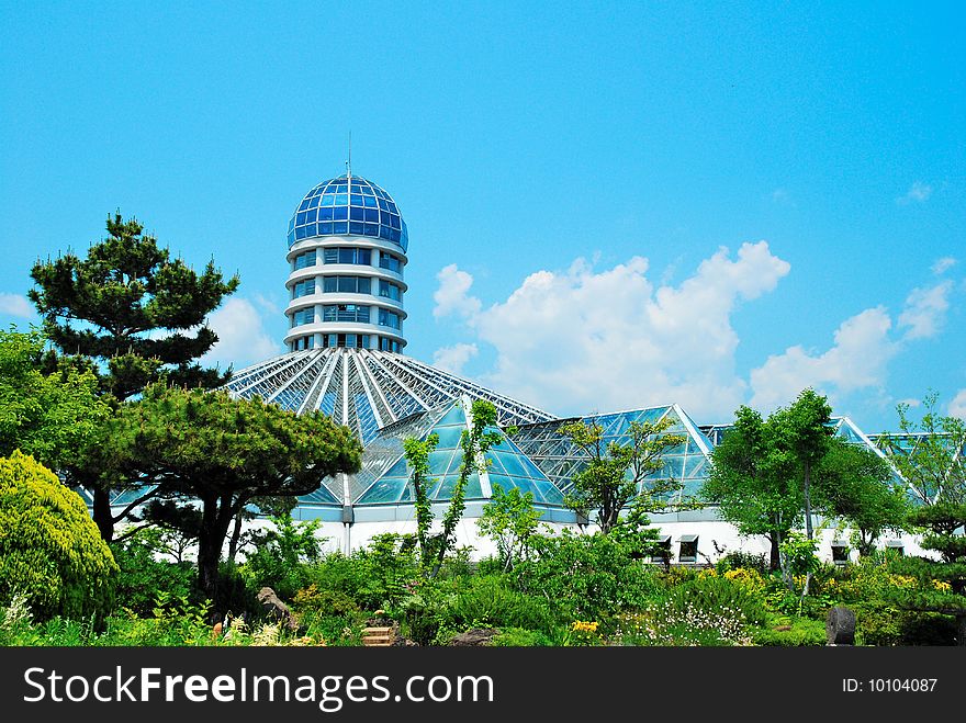 A greenhouse surrounded by trees and natural vegetation