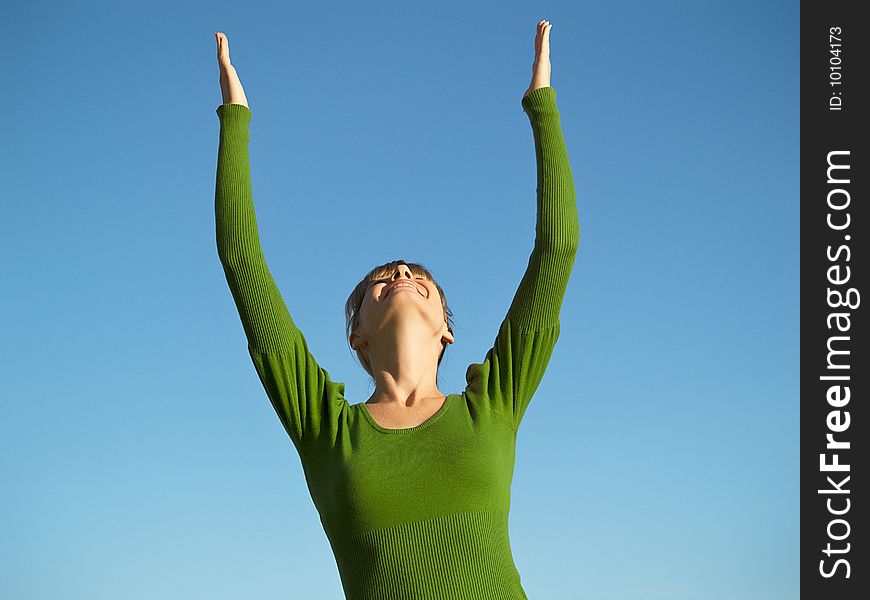 Portrait of the young woman posing on a background of the dark blue sky. Portrait of the young woman posing on a background of the dark blue sky