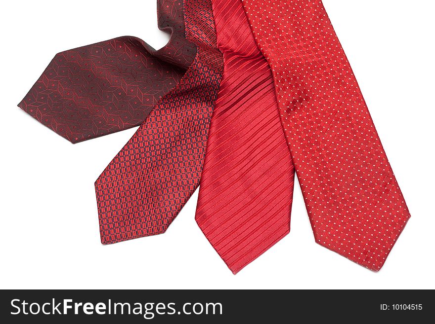 Four male ties, red and crimson on white background